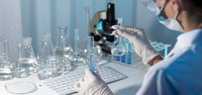 close-up-researcher-holding-glassware